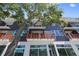Exterior angle shot of a condo building with red railings, large windows, and modern design at 15 29Th N St # Lot 7, St Petersburg, FL 33713