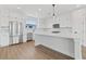 Bright, modern kitchen with stainless steel appliances, white cabinets and a center island at 15 29Th N St # Lot 7, St Petersburg, FL 33713
