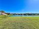 Expansive backyard with lush green grass and a serene lake view, perfect for outdoor activities at 1945 Fruitridge St, Brandon, FL 33510