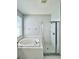 Modern bathroom featuring a large soaking tub and glass-enclosed shower, with tile surround at 1945 Fruitridge St, Brandon, FL 33510