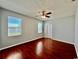 Bright bedroom with hardwood floors, ceiling fan and view of water from two windows at 1945 Fruitridge St, Brandon, FL 33510