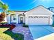 Beautiful exterior featuring a two-car garage, brick walkway, and manicured lawn at 1945 Fruitridge St, Brandon, FL 33510