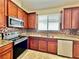 Kitchen showcases granite countertops, stainless steel appliances, and ample cabinetry at 1945 Fruitridge St, Brandon, FL 33510
