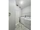 Clean laundry room featuring a new washer, dryer, shelving, and stylish hexagonal tile flooring at 1945 Fruitridge St, Brandon, FL 33510