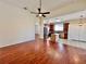 Open-concept living room with hardwood floors flows into kitchen featuring an island and stainless steel appliances at 1945 Fruitridge St, Brandon, FL 33510