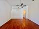 Spacious living room with vaulted ceilings, modern ceiling fan, and wood flooring at 1945 Fruitridge St, Brandon, FL 33510