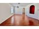 Bright living room with hardwood floors, fresh paint, and a modern light fixture at 1945 Fruitridge St, Brandon, FL 33510