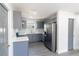 Modern kitchen with gray cabinetry, stainless steel appliances, and a stylish backsplash at 2413 Wishing Well Way, Tampa, FL 33619