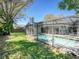 Beautifully landscaped backyard with screened-in pool, creating a private oasis at 2988 Pinewood Run, Palm Harbor, FL 34684