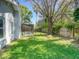 Spacious backyard with screened-in pool and lush lawn, perfect for outdoor activities at 2988 Pinewood Run, Palm Harbor, FL 34684