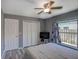 This bedroom features a double bed, hardwood floors, and a ceiling fan, plus a closet for storage at 2988 Pinewood Run, Palm Harbor, FL 34684