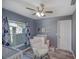 This bedroom is decorated as a baby's room, with crib, rocker, and hardwood floors, plus a ceiling fan at 2988 Pinewood Run, Palm Harbor, FL 34684