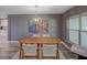 Cozy dining area featuring a wooden table and chairs with a view of the kitchen at 2988 Pinewood Run, Palm Harbor, FL 34684