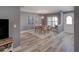 Dining room with modern light fixture and decor near front entrance at 2988 Pinewood Run, Palm Harbor, FL 34684