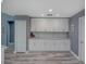 Bright kitchen features shaker cabinets, stone countertops, gray walls, and modern appliances at 2988 Pinewood Run, Palm Harbor, FL 34684