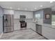 Stylish kitchen with white cabinets, stainless steel appliances, and hardwood floors at 2988 Pinewood Run, Palm Harbor, FL 34684