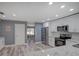 Modern kitchen features stainless steel appliances, white cabinets, and stylish countertops at 2988 Pinewood Run, Palm Harbor, FL 34684