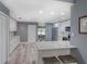 Open-concept kitchen boasts a center island, gray walls, modern appliances, and abundant cabinet space at 2988 Pinewood Run, Palm Harbor, FL 34684