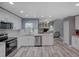 Modern kitchen featuring white cabinets, stainless steel appliances, and hardwood floors at 2988 Pinewood Run, Palm Harbor, FL 34684