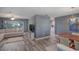 Open-concept living room and dining area with hardwood floors and sliding glass doors at 2988 Pinewood Run, Palm Harbor, FL 34684