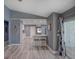 Open living area provides kitchen access, and features stylish seating and barstool area at 2988 Pinewood Run, Palm Harbor, FL 34684