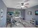 This office space features hardwood floors, a ceiling fan, and plenty of natural light from the nearby window at 2988 Pinewood Run, Palm Harbor, FL 34684