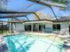 Sparkling pool with screened enclosure and patio area, ideal for outdoor enjoyment at 2988 Pinewood Run, Palm Harbor, FL 34684