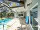 Screened-in pool and patio with ceiling fan offer a great outdoor space at 2988 Pinewood Run, Palm Harbor, FL 34684