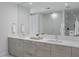 Sleek bathroom with double vanity, ample counter space and a large mirror, with a shower visible behind at 301 1St S St # 1201, St Petersburg, FL 33701
