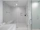 Modern bathroom featuring a glass enclosed shower, soaking tub, and white tile at 301 1St S St # 1201, St Petersburg, FL 33701