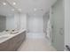Modern bathroom featuring dual sinks, a soaking tub, and a glass-enclosed shower for a spa-like experience at 301 1St S St # 1201, St Petersburg, FL 33701