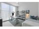 This bedroom features a ceiling fan and a large window to offer city views at 301 1St S St # 1201, St Petersburg, FL 33701