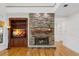 Close-up of stone fireplace with built-in bookcase and wood mantel at 3041 Dominion Ct, Safety Harbor, FL 34695