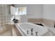 Inviting bathroom with a soaking tub, tiled floors, and a walk in shower with glass blocks at 355 21St Ne Ave, St Petersburg, FL 33704