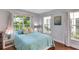 Bright bedroom with ample natural light, calming blue accents, and beautiful hardwood floors for a serene retreat at 355 21St Ne Ave, St Petersburg, FL 33704