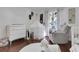 Bright bedroom with a rocking chair, crib and tent for playtime and ample natural light from large window at 355 21St Ne Ave, St Petersburg, FL 33704