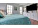 Tranquil bedroom features large windows, hardwood floors, and ample storage with custom built-in cabinets at 355 21St Ne Ave, St Petersburg, FL 33704