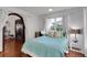 Cozy bedroom with an arched doorway and a view to the staircase; hardwood floors and ample light at 355 21St Ne Ave, St Petersburg, FL 33704