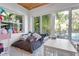 Bright bedroom with a view to the pool; features a comfortable daybed, large windows, and hardwood floors at 355 21St Ne Ave, St Petersburg, FL 33704