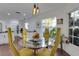 Inviting breakfast nook with a round glass table, modern lighting, and views into the kitchen with white cabinetry at 355 21St Ne Ave, St Petersburg, FL 33704