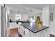 Modern kitchen features a large island with dark countertops, white cabinetry, and stainless steel appliances at 355 21St Ne Ave, St Petersburg, FL 33704