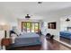 Well-lit main bedroom with wooden floors, a large TV, sliding doors to patio, and neutral color palette at 355 21St Ne Ave, St Petersburg, FL 33704