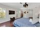 Spacious main bedroom with dark wood floors, a large flat screen tv, and modern furnishings at 355 21St Ne Ave, St Petersburg, FL 33704