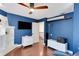 Spacious office featuring hardwood floors, a TV, cabinets and a ceiling fan at 355 21St Ne Ave, St Petersburg, FL 33704