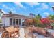 Spacious outdoor patio with a dining table, lounge chairs, colorful flowers and a seating area at 355 21St Ne Ave, St Petersburg, FL 33704