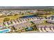 Aerial view of community featuring a pond, tennis court, pool, and lush landscaping at 3753 Maxwell Park Dr, Sun City Center, FL 33573