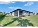 Well-manicured backyard with lush green grass and a screened lanai on an attached home at 3753 Maxwell Park Dr, Sun City Center, FL 33573