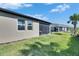 Exterior view of a well-maintained backyard and screened-in lanai perfect for outdoor living at 3753 Maxwell Park Dr, Sun City Center, FL 33573