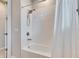 Modern bathroom with a shower featuring white tile and bright lighting at 3753 Maxwell Park Dr, Sun City Center, FL 33573