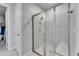 A glass-enclosed shower with tiled walls is next to the ensuite entry at 3753 Maxwell Park Dr, Sun City Center, FL 33573